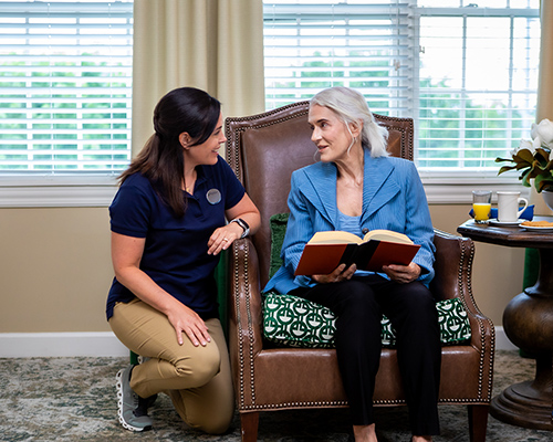 caregiver helping a resident paint